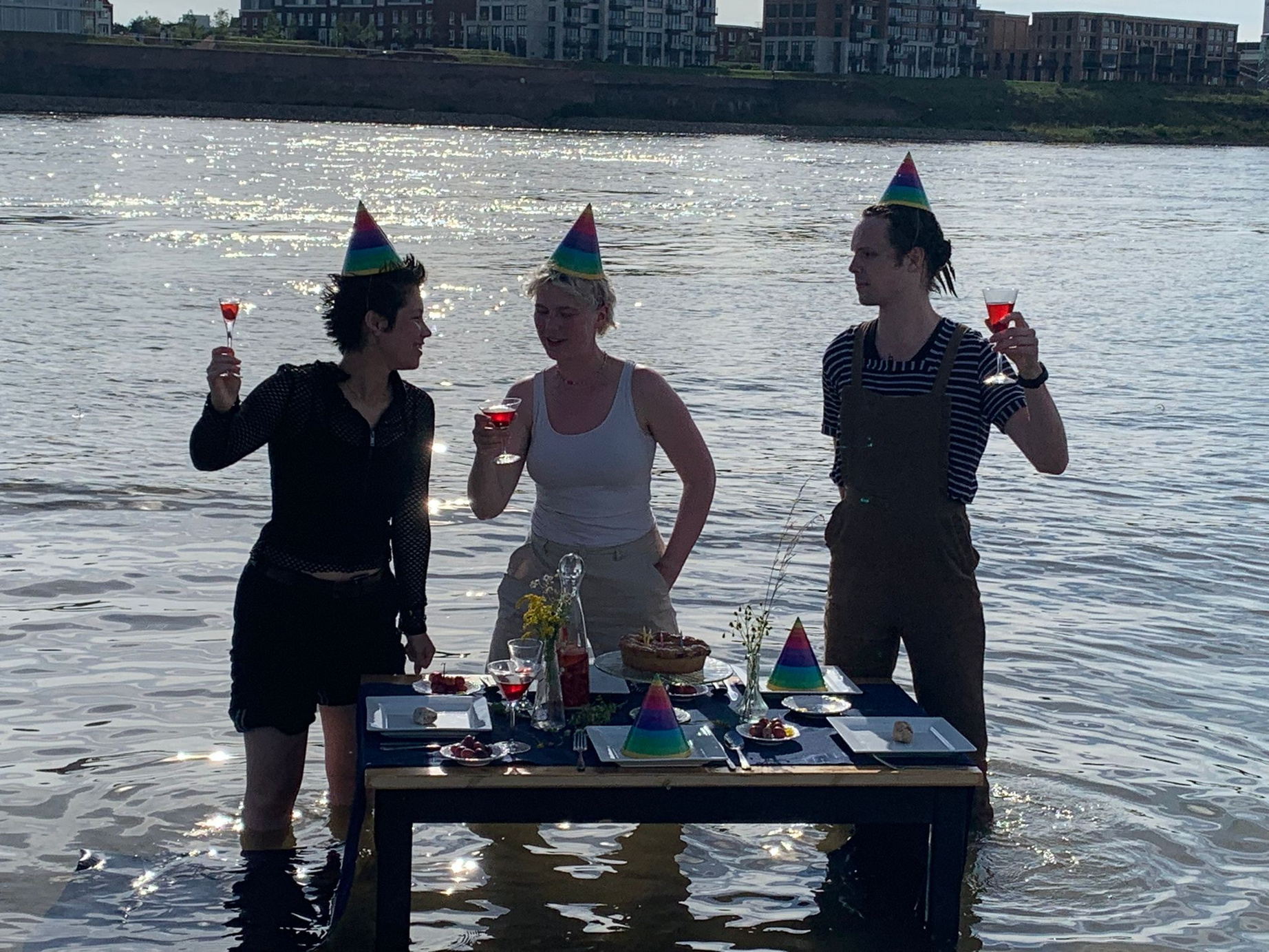 three people wearing party hats in the water